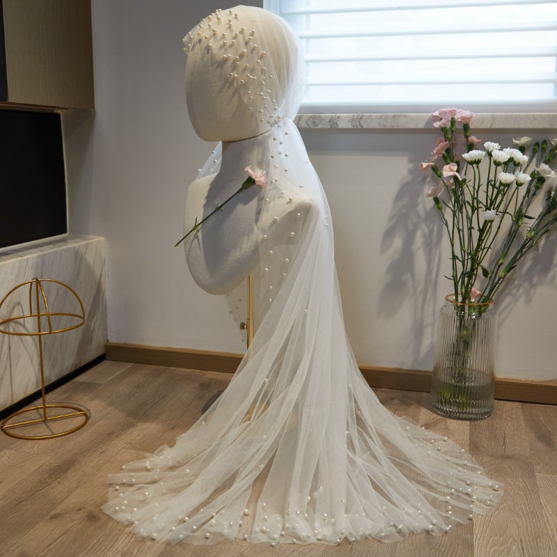Flowing pearl embellished white wedding veil