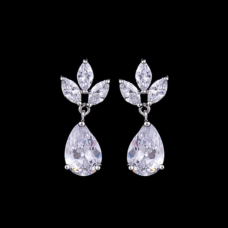 Pair of Isla crystal teardrop bridal earrings displayed against a black background