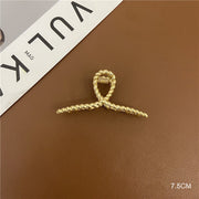 Gold tone hair clip with curved shape options
