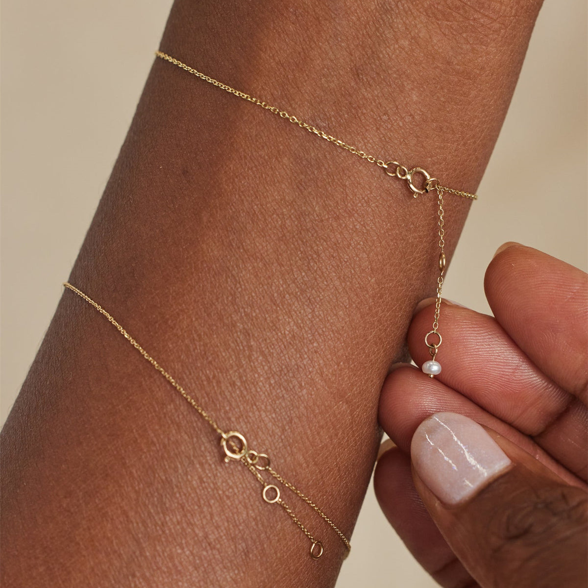 Margot gold-tone bracelet showing its delicate chain and clasp detail on the wrist