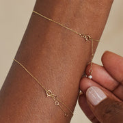 Margot gold-tone bracelet showing its delicate chain and clasp detail on the wrist