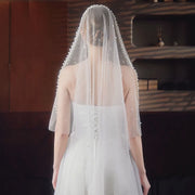 Amélie white pearl-trim bridal veil shown in a product video