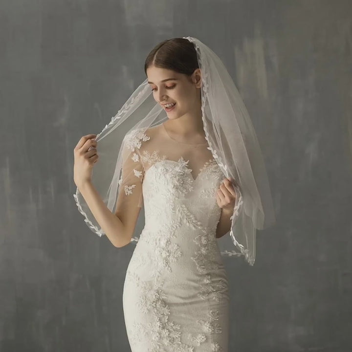 Model wearing the Florence Botanical Leaf bridal veil, showing its leaf detailing and drape.