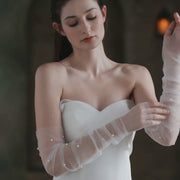 Isla sheer bridal gloves with pearl accents shown in a product video