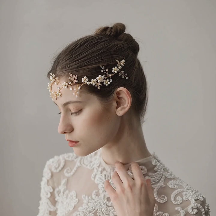 Model wearing the Aurelia Pearl Blossom bridal hair vine, showing its floral details and placement.